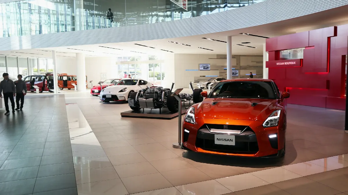 A bright car showroom with rows of new vehicles on display