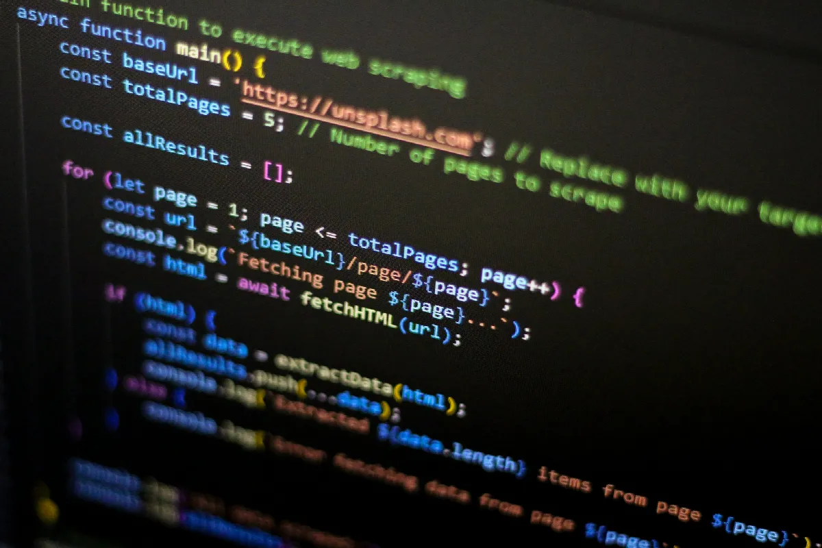 Close-up of a dark code editor with colorful JavaScript on the screen