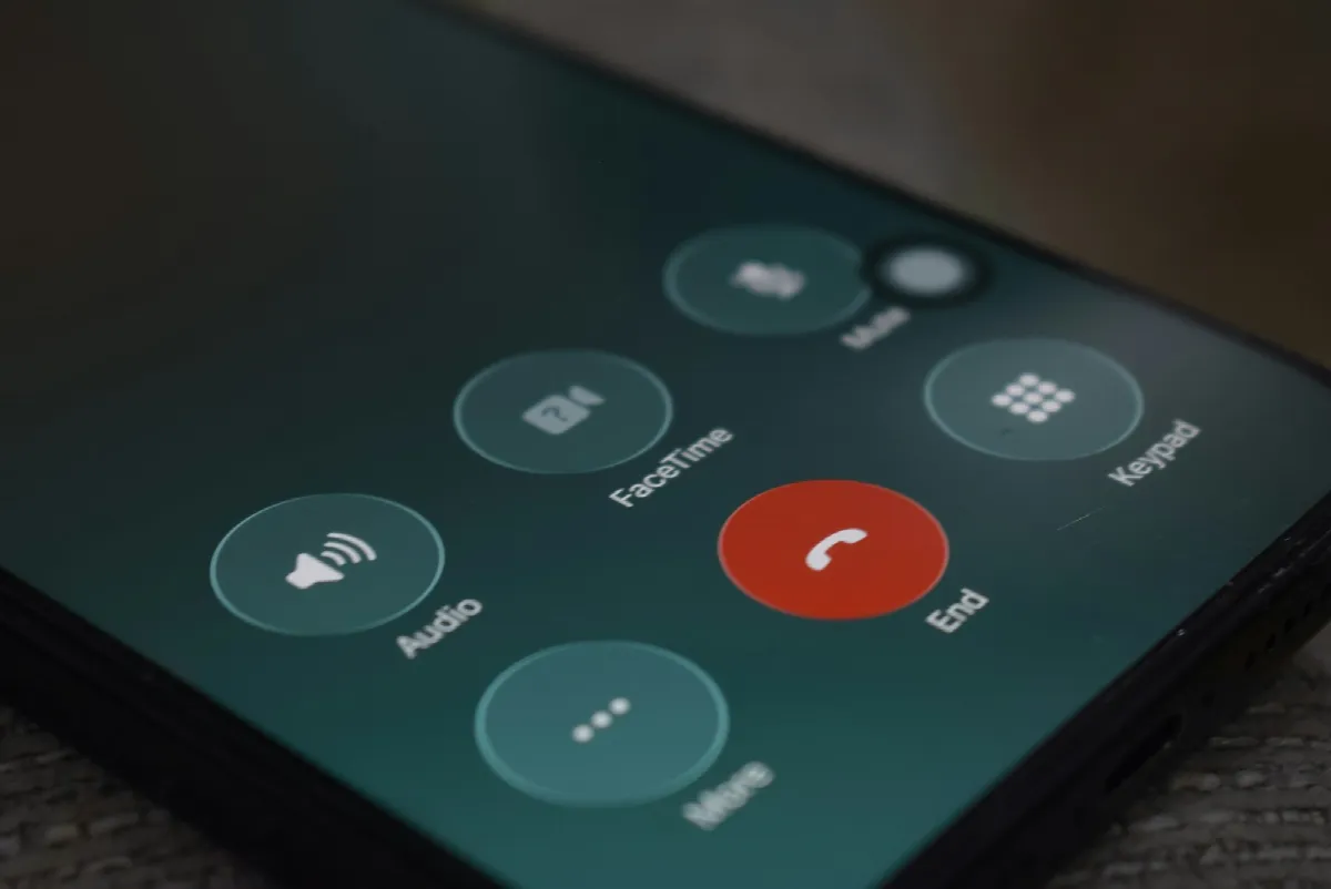 A smartphone screen showing an active call with round audio and video buttons