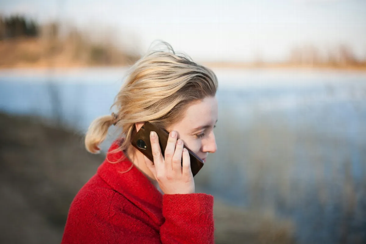A woman holding a phone to her ear while taking a call