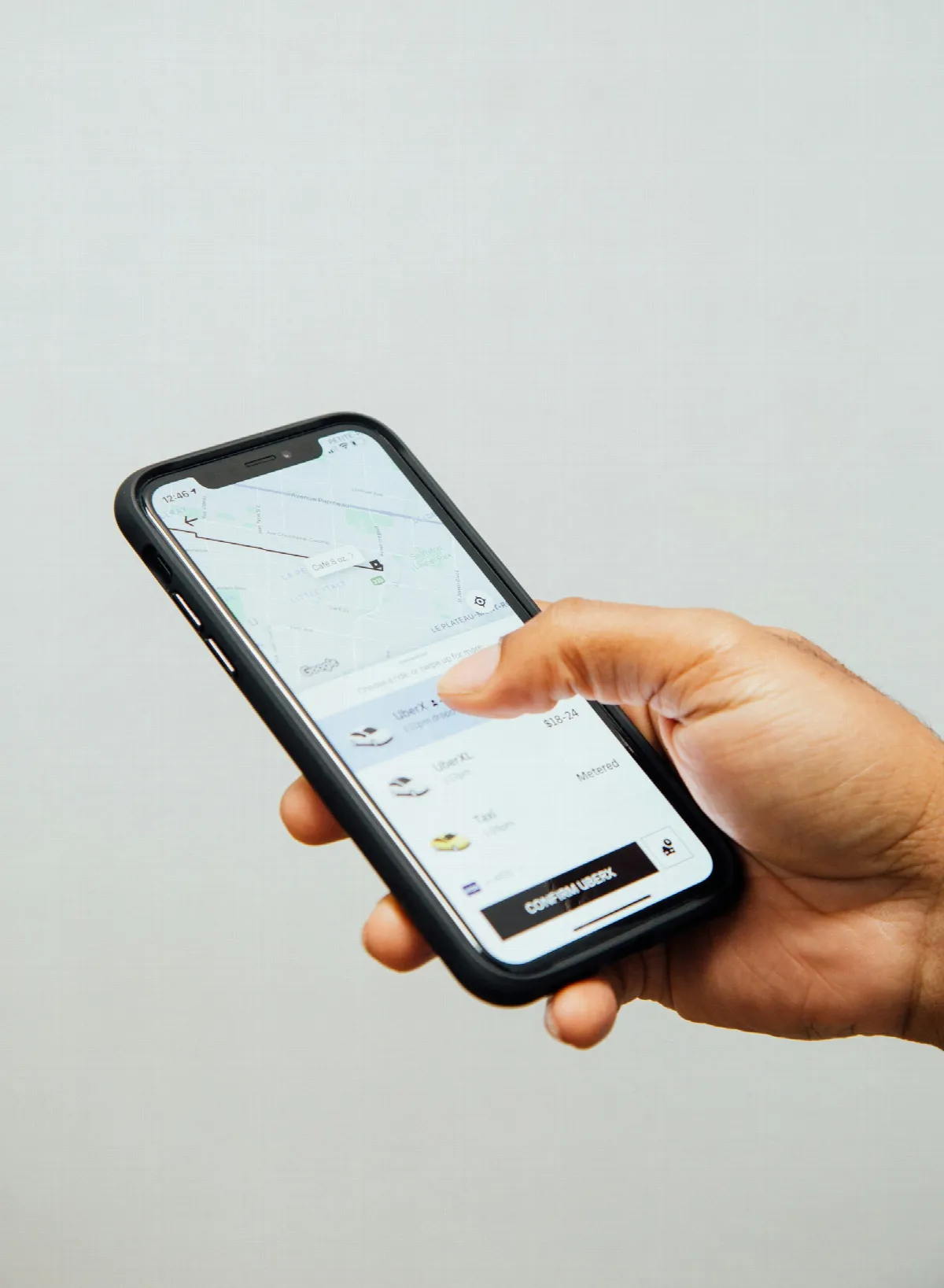 A person holding a smartphone, the usual starting point when you need to find an address from a phone number