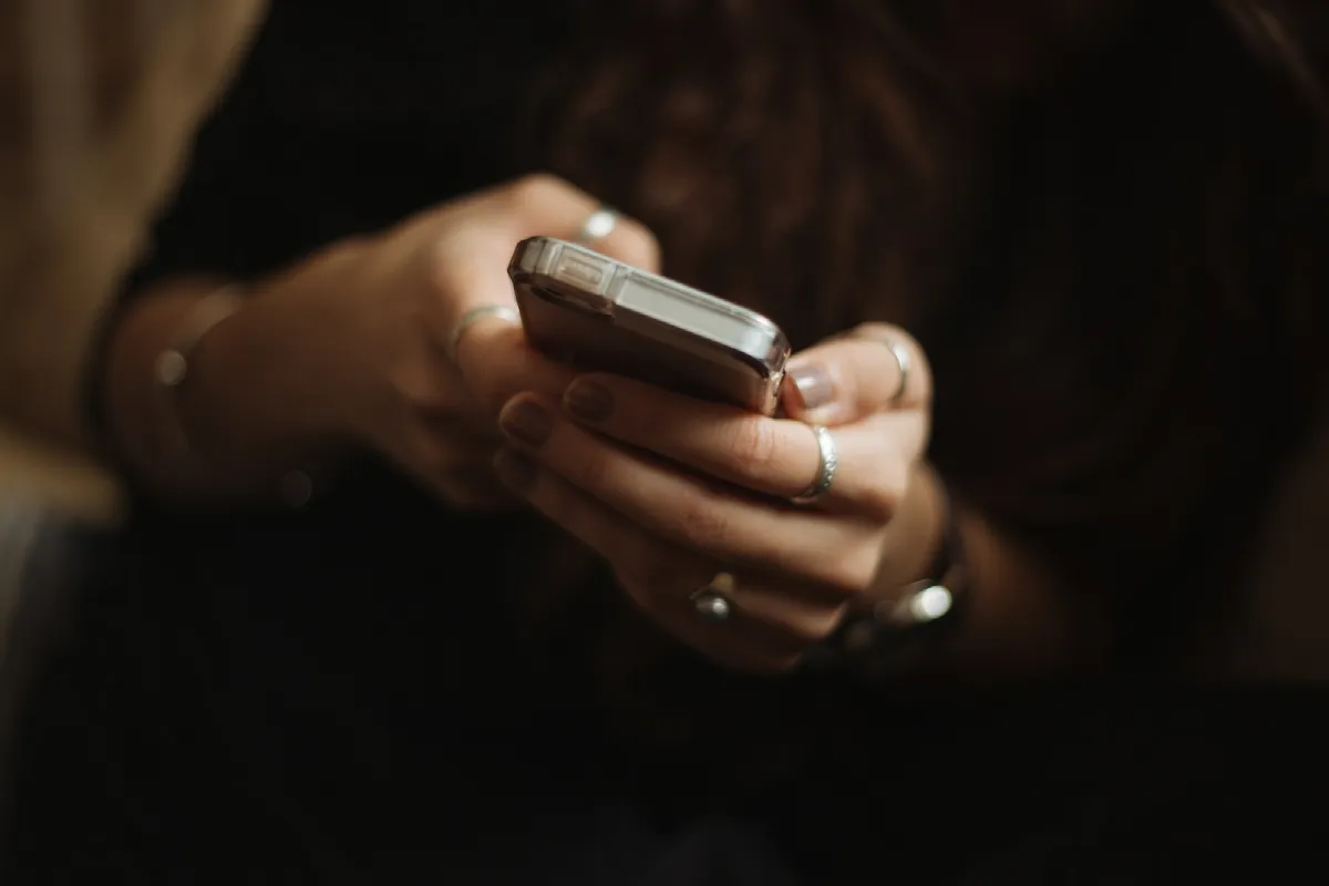 A person holding a smartphone, the kind of mobile line a phone line type lookup identifies